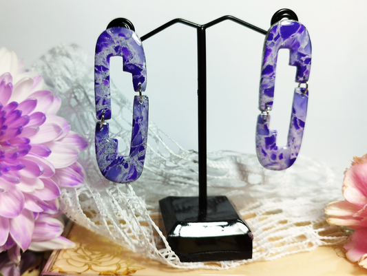 Aztec with an Arch connected with another Aztec with an Arch in Violet, White, Periwinkle and Purple with Silver sparkles colour, Handmade Polymer Clay Earrings. The base of the Earrings is an abstract convex polygon attached to a jump ring to the Abstract Flower shape hanging from it.